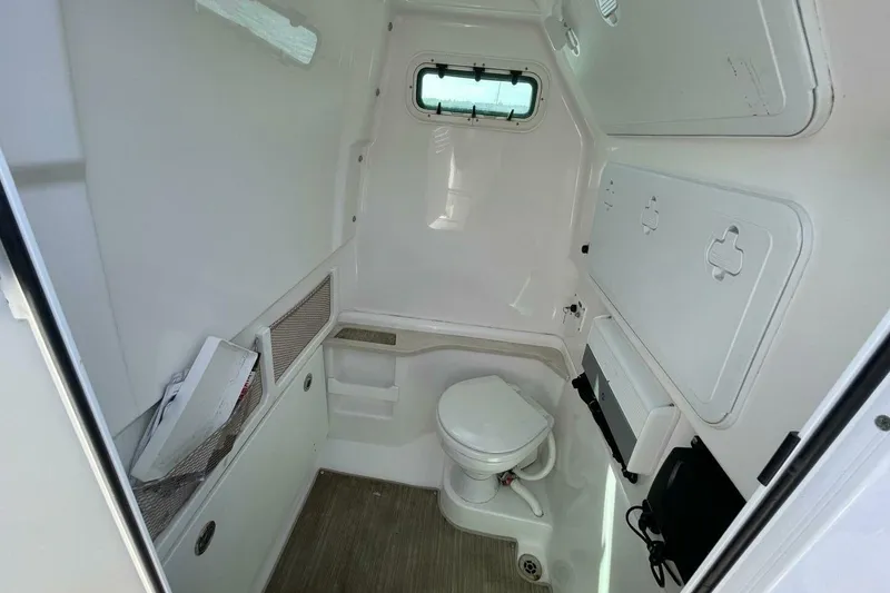 Slide: The Image of Interior of 2019 Everglades 273 Center Console boat with compact marine toilet. - 16