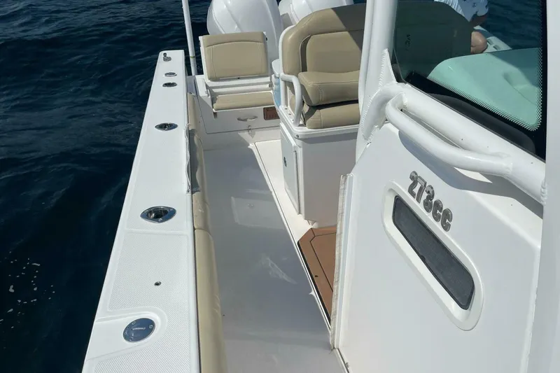 Slide: The Image of 2019 Everglades 273 Center Console boat on water, featuring sleek design and comfortable seating. - 17