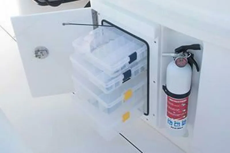 Slide: The Image of Storage compartment with tackle boxes and fire extinguisher on 2019 Everglades 273 Center Console boat. - 19