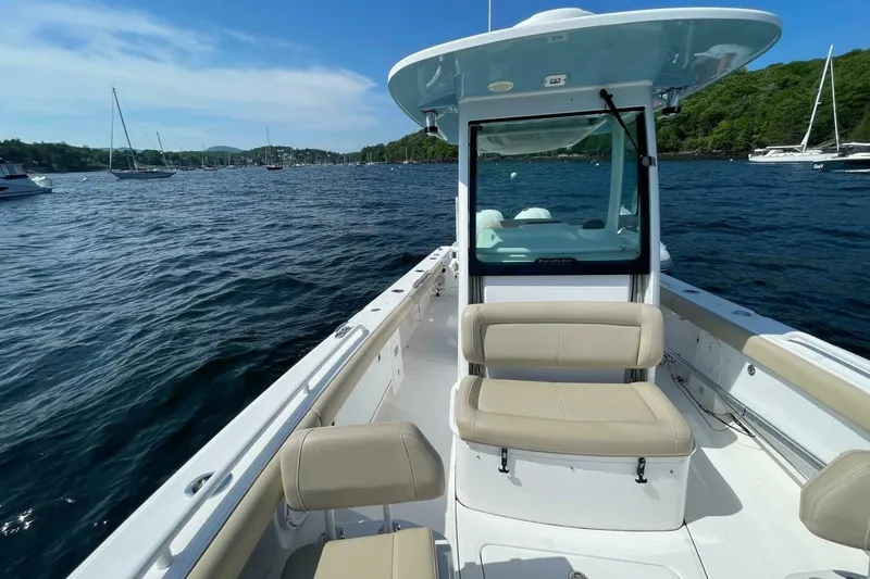 Slide: The Image of 2019 Everglades 273 Center Console boat on a scenic lake with surrounding sailboats. - 20
