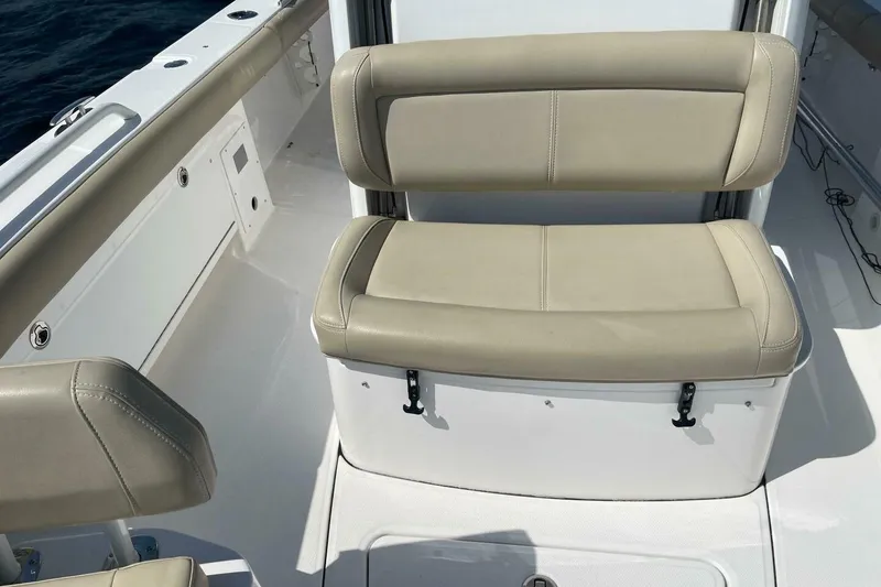 Slide: The Image of 2019 Everglades 273 Center Console boat interior with beige seating and white deck. - 21