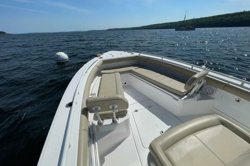 Slide: The Image of 2019 Everglades 273 Center Console boat on open water, featuring spacious seating. - 23