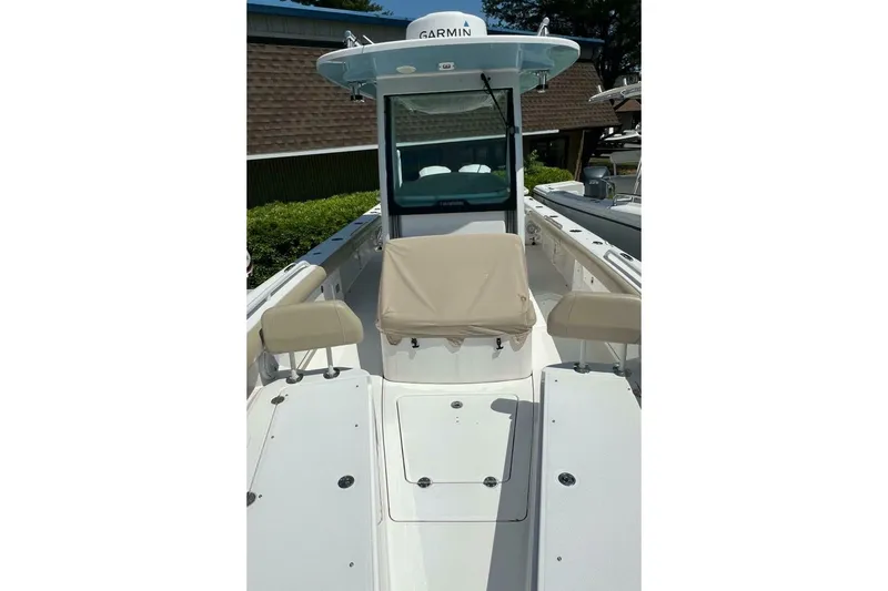 Slide: The Image of 2019 Everglades 273 Center Console boat with Garmin equipment, beige seating, and spacious deck. - 29