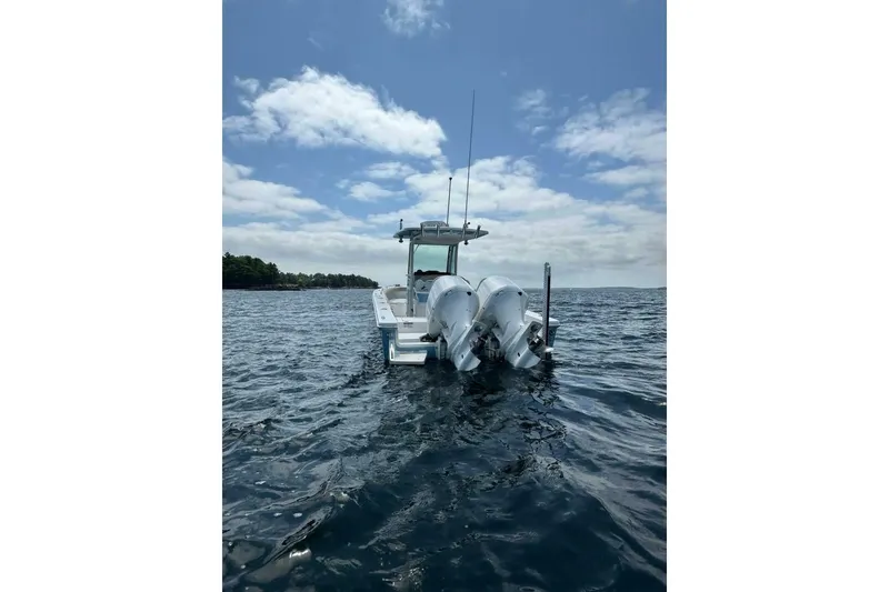 Slide: The Image of 2019 Everglades 273 Center Console boat on open water under a partly cloudy sky. - 5