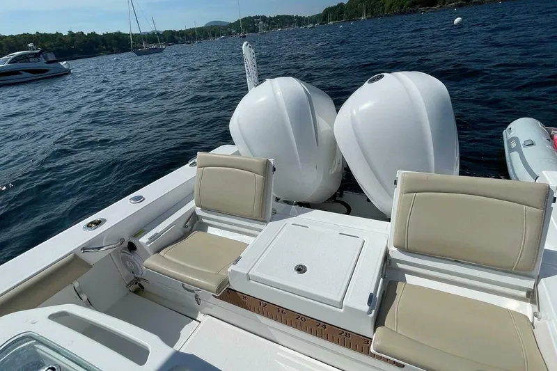 Slide: The Image of 2019 Everglades 273 Center Console boat with dual engines on a scenic lake. - 7