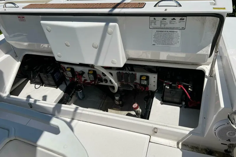 Slide: The Image of 2019 Everglades 273 Center Console boat electrical compartment with batteries and wiring. - 8