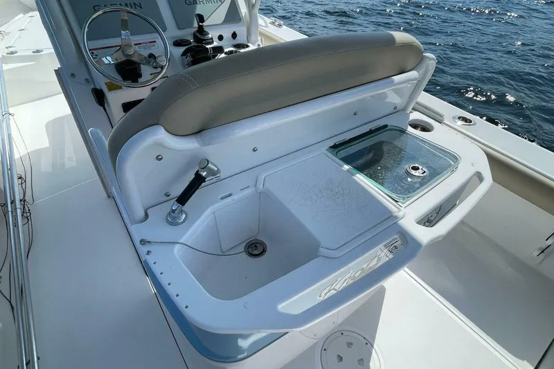Slide: The Image of 2019 Everglades 273 Center Console boat with helm and seating, on open water. - 9