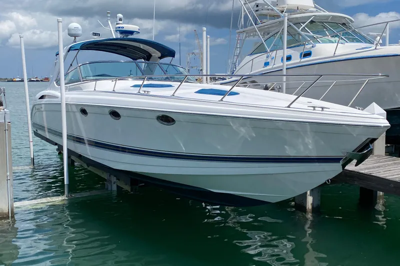 The Image of 1999 Formula 400 Super Sport boat docked at marina with cruise ship in background. - 0