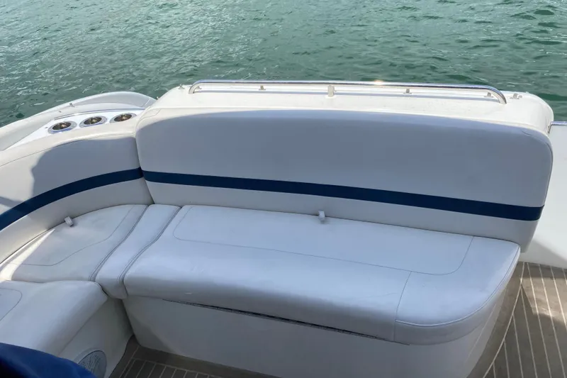 Slide: The Image of White seating on a 1999 Formula 400 Super Sport boat, near water. - 12