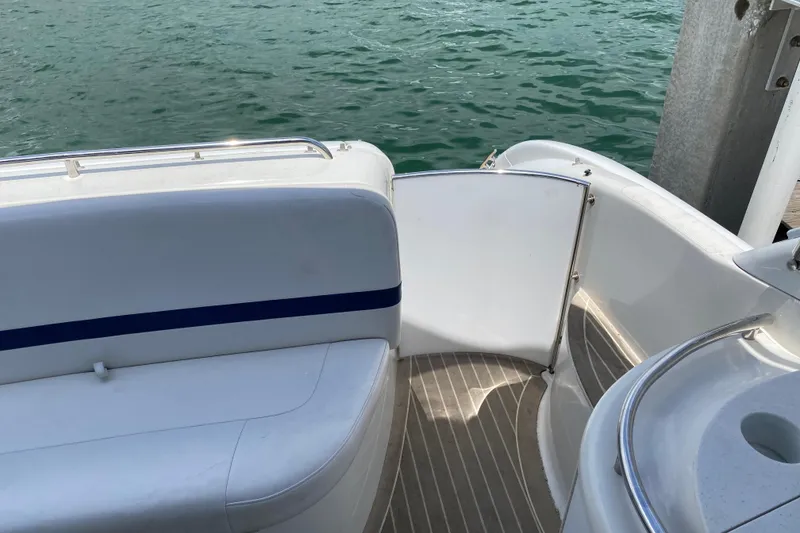 Slide: The Image of 1999 Formula 400 Super Sport boat interior with open gate, docked by water. - 13