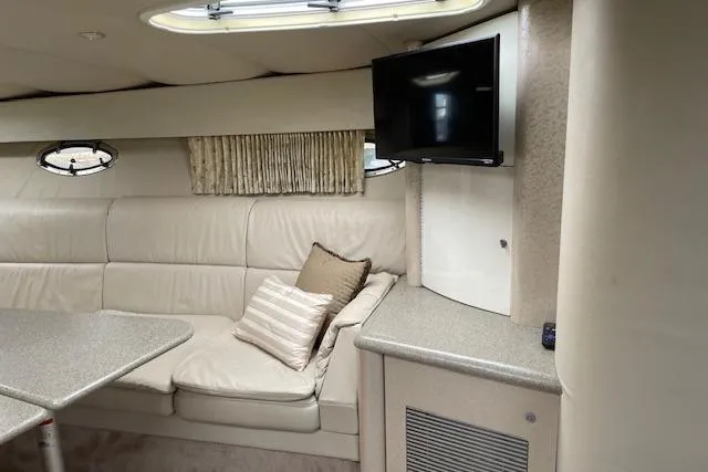 Slide: The Image of Interior of a 1999 Formula 400 Super Sport boat with seating, table, and TV. - 15