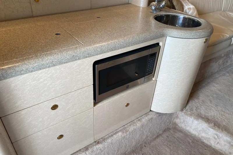 Slide: The Image of 1999 Formula 400 Super Sport interior with microwave, sink, and cabinetry. - 18