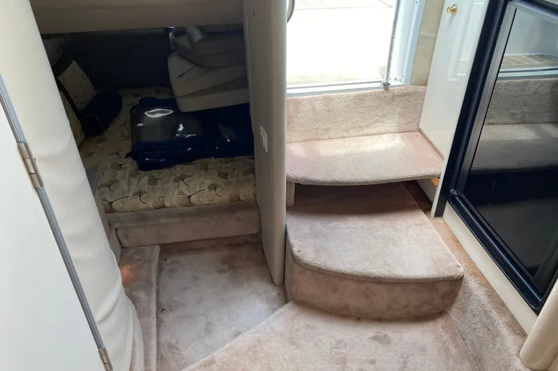 Slide: The Image of Interior cabin of 1999 Formula 400 Super Sport boat with carpeted steps and seating area. - 22