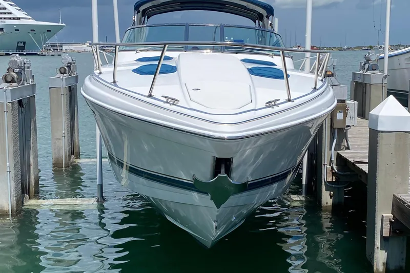 Slide: The Image of 1999 Formula 400 Super Sport boat docked at marina, clear sky, calm water. - 3