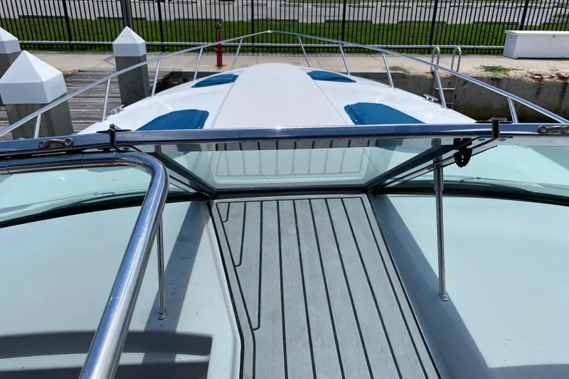 Slide: The Image of 1999 Formula 400 Super Sport boat deck with sleek design and stainless steel railings. - 4