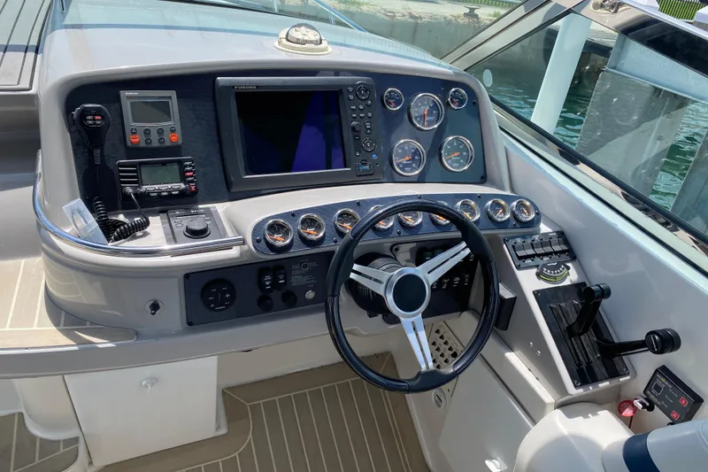 Slide: The Image of Control panel of a 1999 Formula 400 Super Sport boat with steering wheel and gauges. - 5