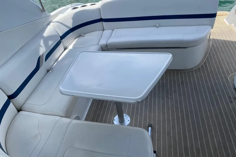Slide: The Image of 1999 Formula 400 Super Sport boat interior with white seating and table. - 8