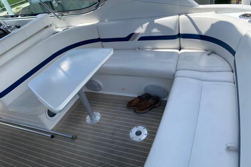 Slide: The Image of 1999 Formula 400 Super Sport boat interior with white seating and table. - 9