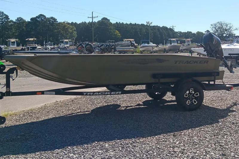 Slide: The Image of 2026 Tracker Grizzly 1650 T Prairie Wings Edition boat with Mercury engine on trailer. - 4