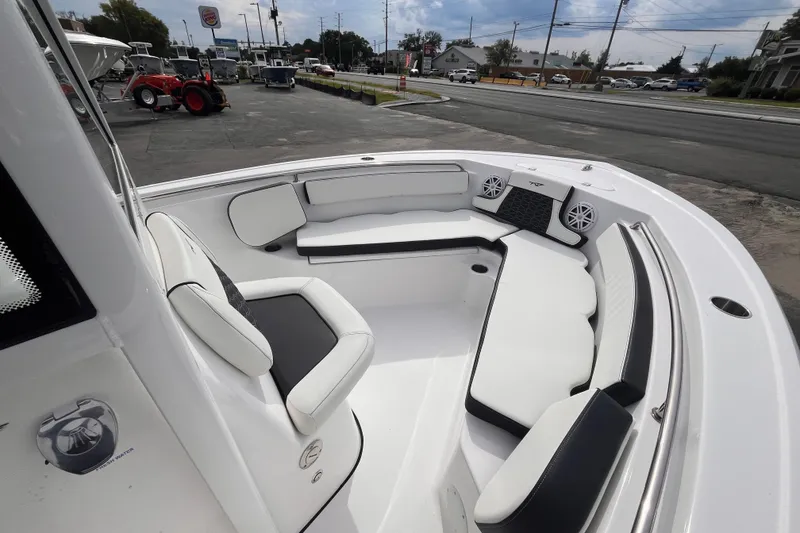 Slide: The Image of 2026 Tidewater 210 LXF boat interior with white seating and speakers. - 10