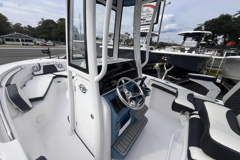 Slide: The Image of 2026 Tidewater 210 LXF boat interior with modern steering and seating. - 13
