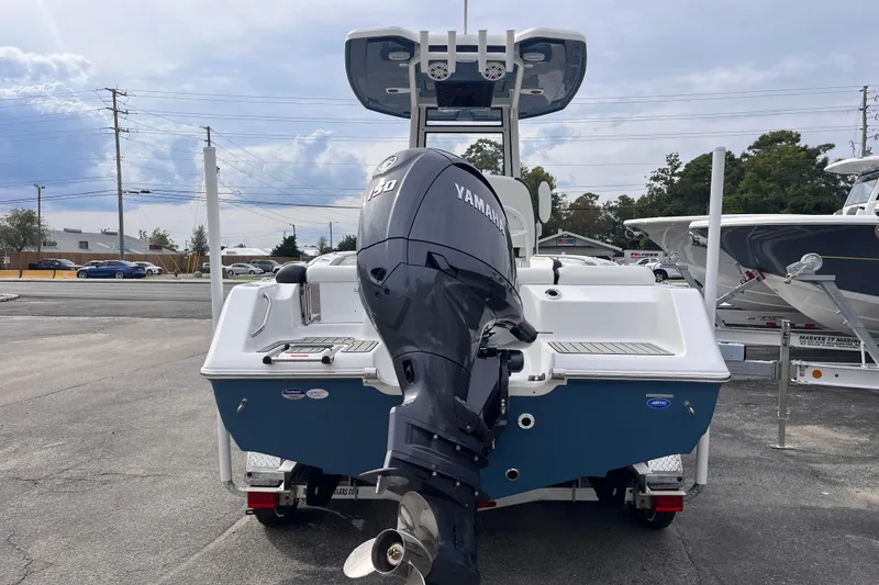 Slide: The Image of 2026 Tidewater 210 LXF boat with Yamaha 150 engine, parked outdoors. - 3