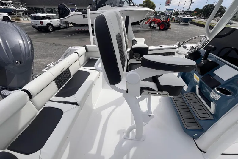 Slide: The Image of 2026 Tidewater 210 LXF boat interior with modern seating and steering console. - 6