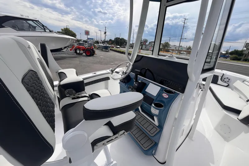 Slide: The Image of 2026 Tidewater 210 LXF boat interior with modern helm and seating. - 7
