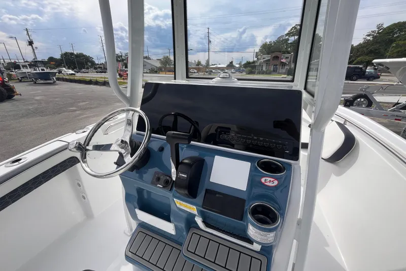 Slide: The Image of 2026 Tidewater 210 LXF boat console with steering wheel and control panel. - 8