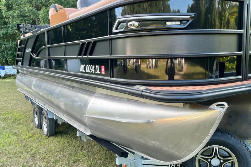 Slide: The Image of 2025 Bentley Pontoons 220/223 Elite Admiral on trailer, side view, black exterior. - 10
