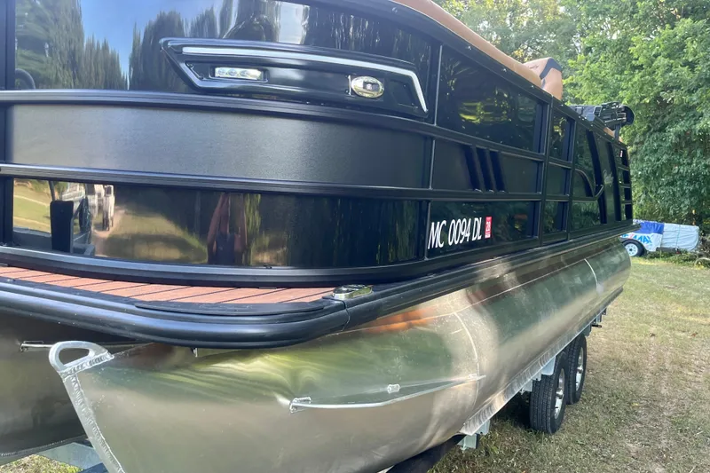 Slide: The Image of 2025 Bentley Pontoons 220/223 Elite Admiral on trailer, side view in outdoor setting. - 11