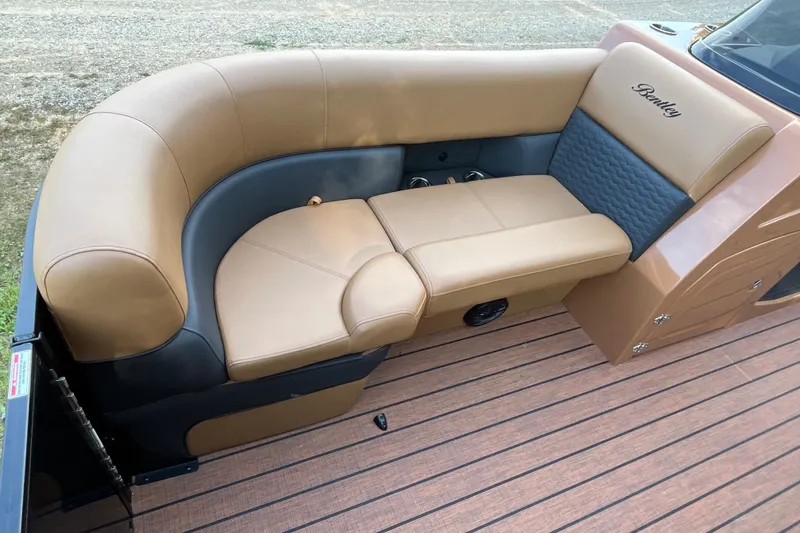 Slide: The Image of Luxurious seating on 2025 Bentley Pontoons 220/223 Elite Admiral boat, featuring tan and gray upholstery. - 14