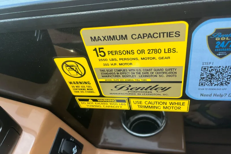 Slide: The Image of 2025 Bentley Pontoons 220/223 Elite Admiral capacity label, 15 persons or 2780 lbs, safety warnings. - 23