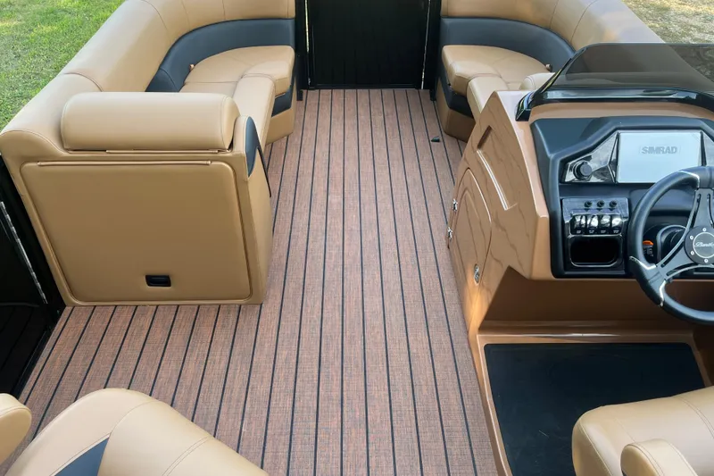 Slide: The Image of 2025 Bentley Pontoons 220/223 Elite Admiral interior with tan seating and modern dashboard. - 28
