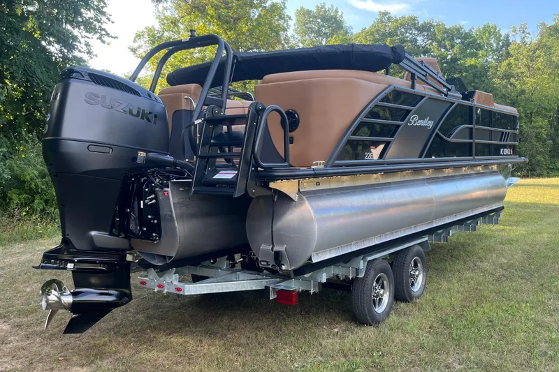 Slide: The Image of 2025 Bentley Pontoons 220/223 Elite Admiral on trailer, featuring Suzuki outboard motor. - 8