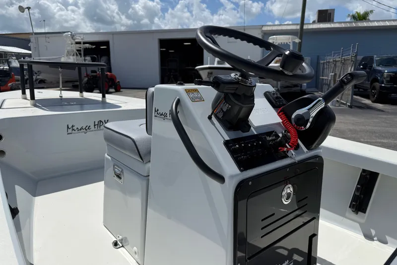 Slide: The Image of 2026 Maverick 17HPX-S boat console with steering wheel and controls, docked outdoors. - 11
