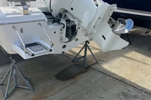 Slide: The Image of 2023 Sea Pro 199 Deep V Center Console boat on stands, showing engine and propeller. - 1