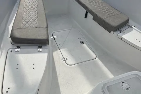 Slide: The Image of 2023 Sea Pro 199 Deep V Center Console boat interior with cushioned seating and storage compartments. - 12