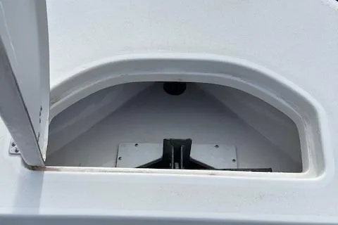 Slide: The Image of 2023 Sea Pro 199 Deep V Center Console storage compartment, open lid, white interior. - 14