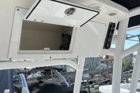 Slide: The Image of 2023 Sea Pro 199 Deep V Center Console boat, featuring an open storage compartment. - 19