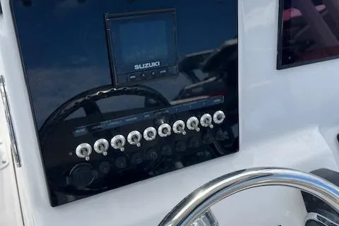 Slide: The Image of 2023 Sea Pro 199 Deep V Center Console dashboard with Suzuki controls and steering wheel. - 5