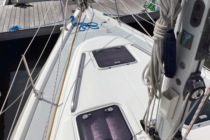 Slide: The Image of Deck view of a 2001 Hunter 380 sailboat docked at a marina. - 13