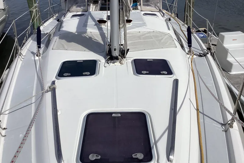 Slide: The Image of 2001 Hunter 380 sailboat deck with hatches and rigging, docked at marina. - 14