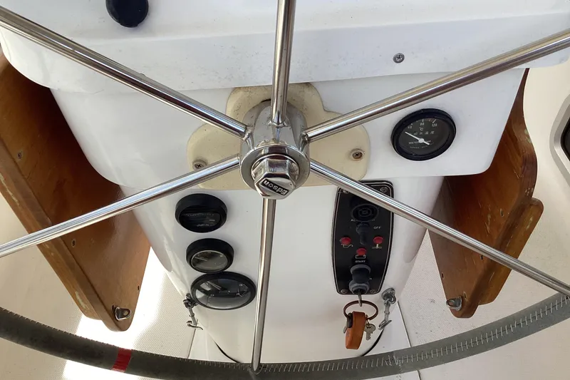Slide: The Image of Steering wheel and controls of a 2001 Hunter 380 sailboat cockpit. - 17