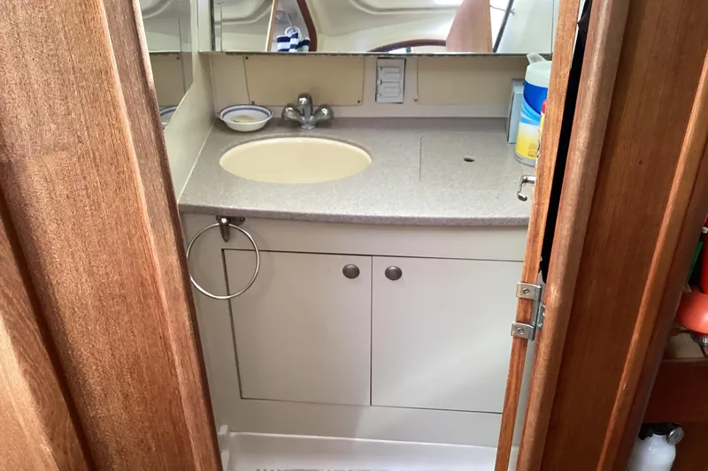 Slide: The Image of Bathroom interior of a 2001 Hunter 380 sailboat with sink and mirror. - 27