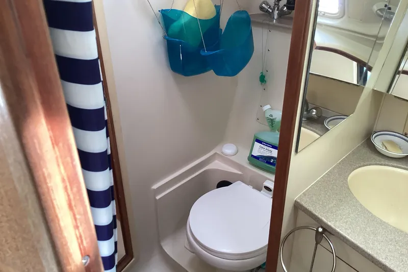 Slide: The Image of Compact bathroom in a 2001 Hunter 380 sailboat with toilet and sink. - 28