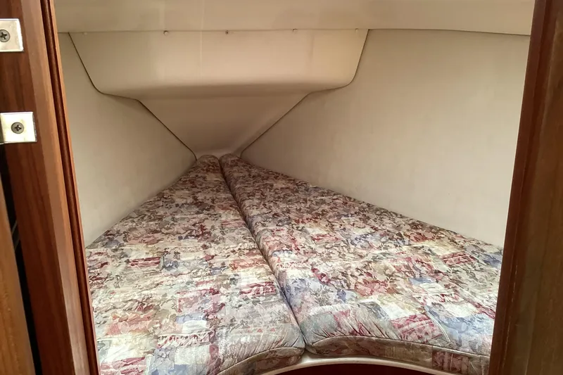 Slide: The Image of Cozy cabin interior of 2001 Hunter 380 sailboat with patterned bedding. - 36