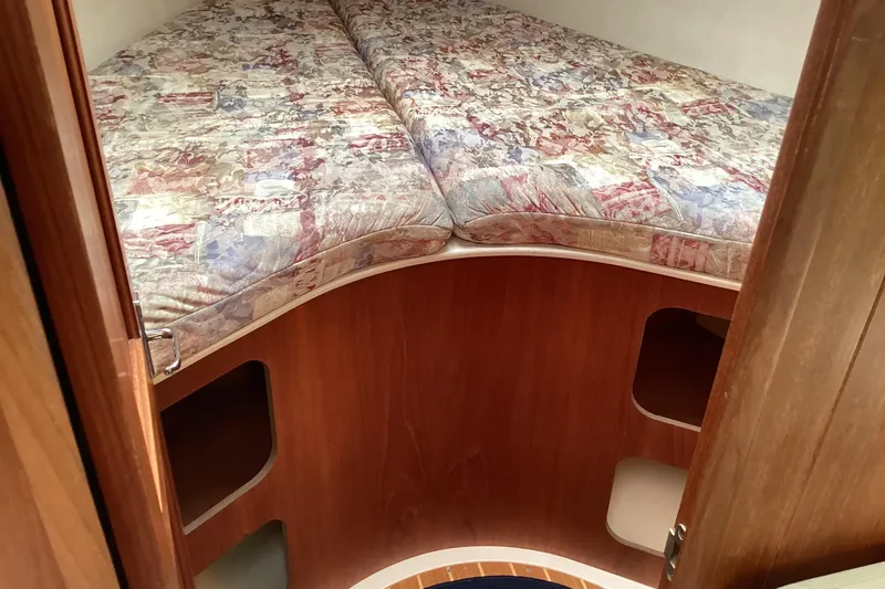 Slide: The Image of Cozy cabin interior of 2001 Hunter 380 sailboat with patterned bedding. - 37