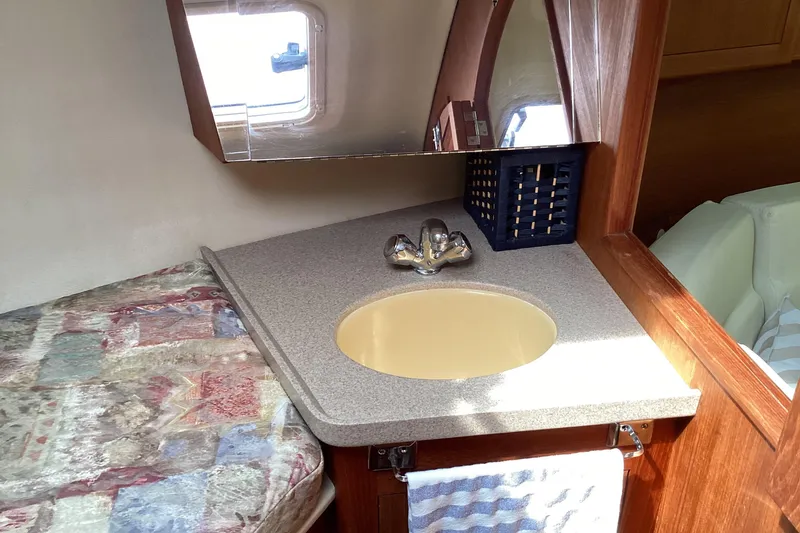 Slide: The Image of Interior of 2001 Hunter 380 sailboat with sink and bed. - 38