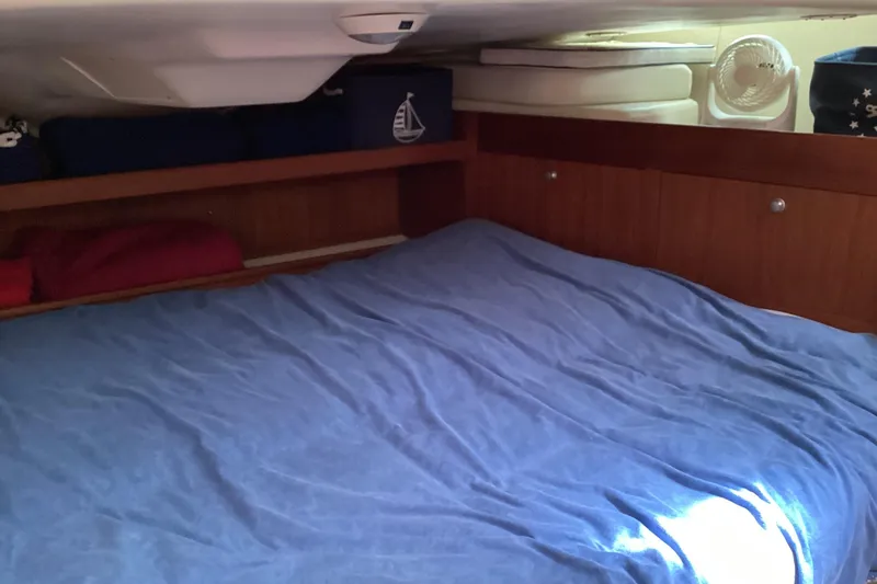 Slide: The Image of Cozy cabin interior of a 2001 Hunter 380 sailboat with blue bedding. - 40